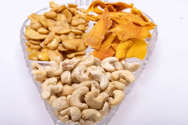 Roasted and salted fava beans, cashew nuts and dried mango slices for a healthy vegan and vegetarian diet snack. High in protein, vitamins, dietary fibre and nutrients