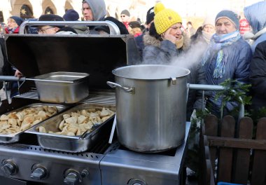 Krakow, Polonya - 18 Aralık 2022: Krakow 'daki ana meydandaki fakir ve evsizler için Noel arifesi. Kosciuszko grubu Krakow 'daki açık havada en büyük arifeyi hazırlıyor