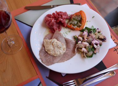 A delicious starter from Piedmont. Steak tartare, carpaccio, stuffed peppers, and salad