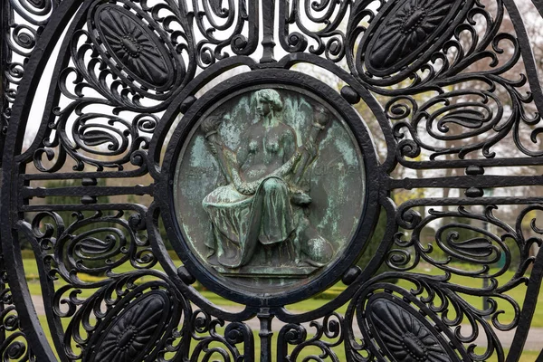 The Hague, Netherlands - April 17, 2023: Figure of Friendship (Amicitia) on the black wrought iron gates of the Peace Palace in The Hague, which houses the International Court of Justice