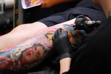 Krakow, Poland -  June 11, 2022: Unidentified  participant at 15th Tattoofest Convention in Cracow. One of the most prestigious tattoo festivals. Tattoo artist at work. 