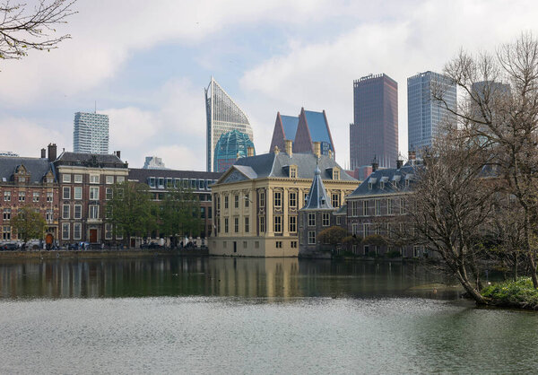 The Hague, Netherlands - April 17, 2023: The Mauritshuis museum building and Binnenhof - Dutch Parliament with Hofvijver pond, The Hague, The Netherlands;