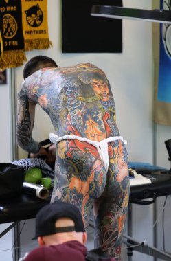 Krakow, Poland -  June 11, 2022: Unidentified  participant at 15th Tattoofest Convention in Cracow. One of the most prestigious tattoo festivals. Tattoo artist at work. 