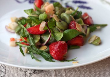 salad with strawberries and broad beans. Delicious dish in a healthy style