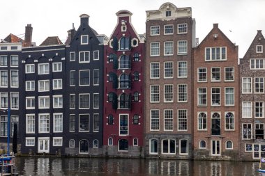 Amsterdam, Hollanda - 21 Nisan 2023: Amsterdam, Hollanda, Hollanda 'da Damrak Caddesi' ndeki tipik gengelli evler