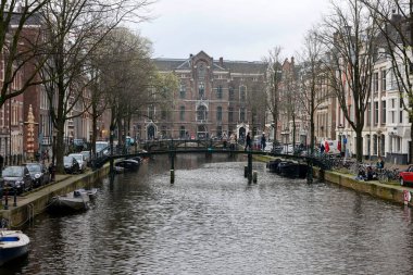 Amsterdam, Hollanda - 21 Nisan 2023: De Wallen - genelev bölgesi olarak adlandırıldı. Eğlence karakteri ile ünlüdür: kanallar boyunca yer alan kardeşler, kahve dükkanları, barlar ve restoranlar.