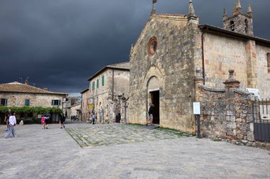 Monteriggioni, İtalya - 17 Eylül 2022: Monteriggioni ortaçağ duvarlı kasabasındaki Piazza Roma, yaklaşan büyük fırtınadan dakikalar önce. Toskana, İtalya