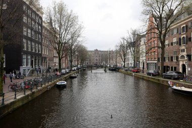 Amsterdam, Hollanda - 21 Nisan 2023: De Wallen - genelev bölgesi olarak adlandırıldı. Eğlence karakteri ile ünlüdür: kanallar boyunca yer alan kardeşler, kahve dükkanları, barlar ve restoranlar.