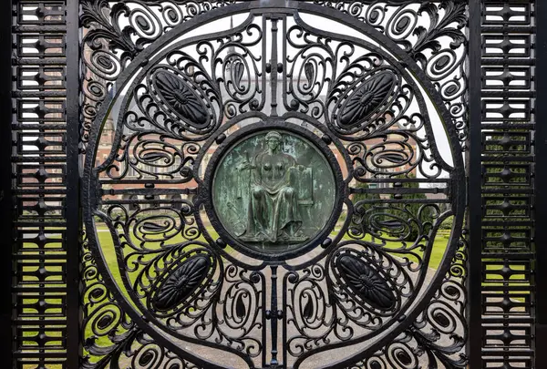 stock image The Hague, Netherlands - April 17, 2023: Figure of Justice (Justitia) on the black wrought iron gates of the Peace Palace in The Hague, which houses the International Court of Justice