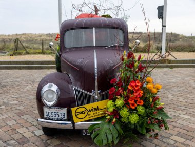 Noordwijk, Netherlands - April 22, 2023: Cars decorated with flowers taking part in the Bloemencorso Bollenstreek the annual spring flower parade from Noordwijk to Haarlem in the Netherlands.  clipart