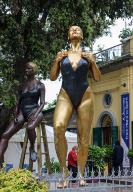 Venice, Italy - May 7 2024:  60th Venice Art Biennale in Venice. Patinated bronze sculptures My body my rules and Tranquility by Carole A. Feuerman. clipart