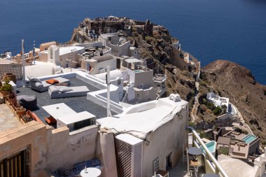 Oia, Santorini, Yunanistan - 3 Temmuz 2021: Yunanistan 'ın Santorini kentindeki Caldera uçurumunun kıyısındaki Agios Nikolaos Kalesi' nin kalıntıları ve Beyazyıkanmış binalar