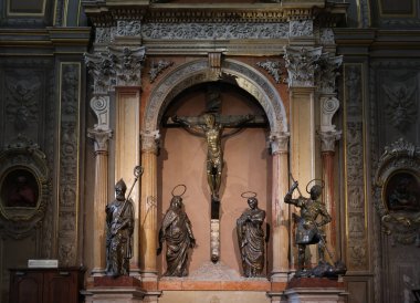 Ferrara, Italy - May 8, 2024: Bronze statues of the Crucifixion, by Niccol Baroncelli in Ferrara cathedral, Basilica Cattedrale di San Giorgio, Ferrara, Italy. clipart