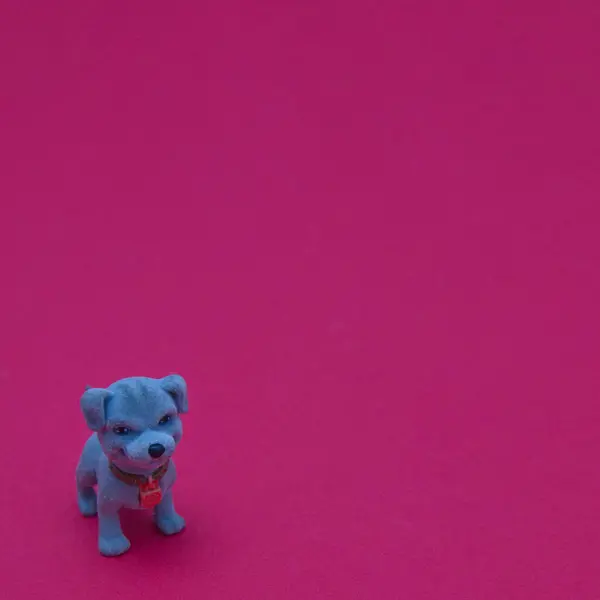 A blue dog in the lower left corner on a red background. Minimal love pets scene.