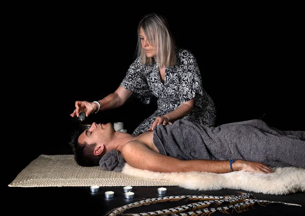 man and energy healing  in front of black background