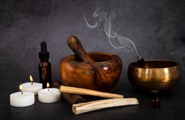 palo santo and mortars in front of dark background
