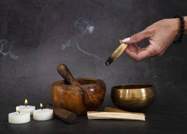 palo santo and mortars in front of dark background