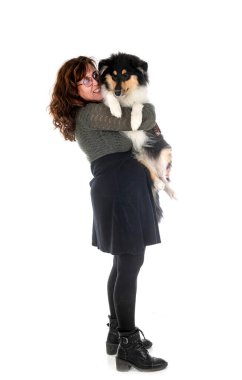young rough collie and woman in front of white background