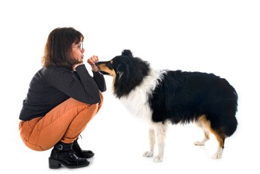 young rough collie and woman in front of white background