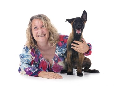 puppy belgian shepherd and woman in front of white background