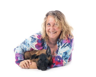 puppy belgian shepherd and woman in front of white background