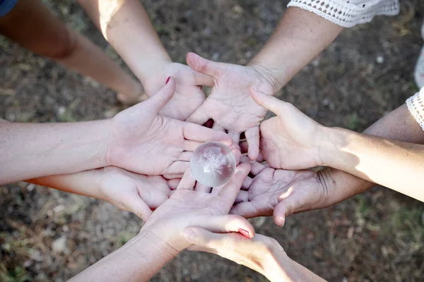 group of people joining hands in the nature