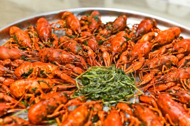 Boiled crayfish with spices in salt with foamy beer for a snack.