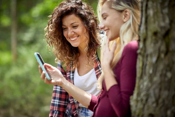 Smiling Girls Forest Watching Mobile Phone — Stock Photo, Image