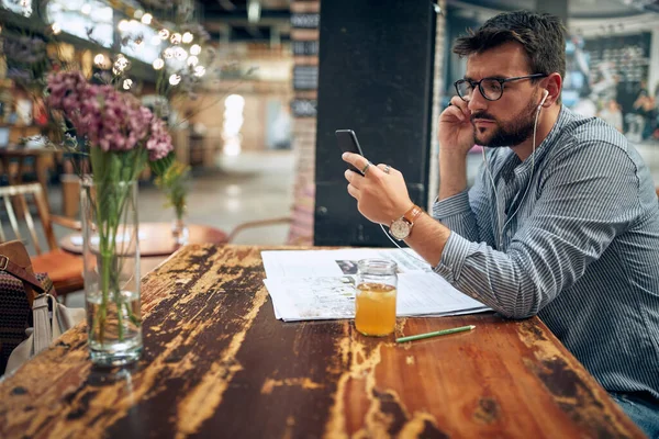 Man Casual Wear Sitting Cafe Alone Using Phone Listening Earphones — Stock Photo, Image