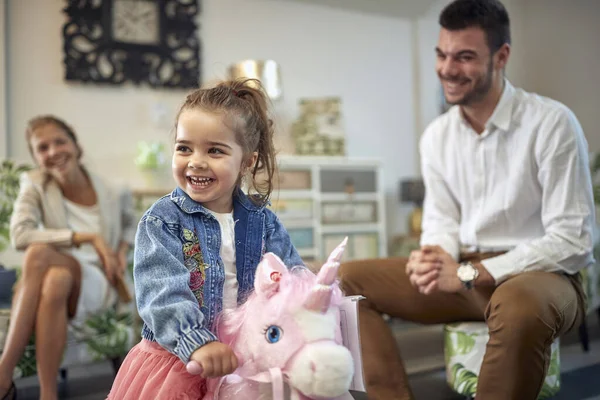 Cute Toddler Girl Riding Pink Unicorn Rocking Horse Furniture Shop — Stock Photo, Image