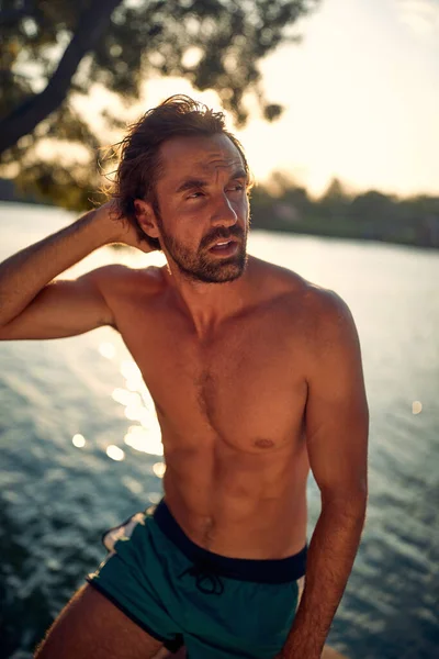 Young Handsome Man Swimsuit Posing Photo While Enjoying Sun Bank — Stock Photo, Image