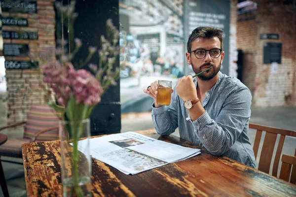 Handsome Young Man Sitting Alone Holding Drink Cafe Looking Distance — Stock Photo, Image