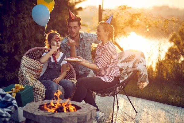 Happy Family Celebrating Birthday Daughter Outdoors Nature Sitting Fireplace Trying — Stock Photo, Image
