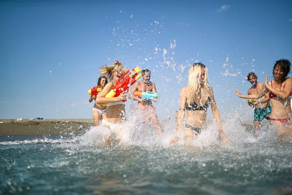 Grupo Amigos Está Divirtiendo Mientras Juega Agua Playa Hermoso Día —  Fotos de Stock