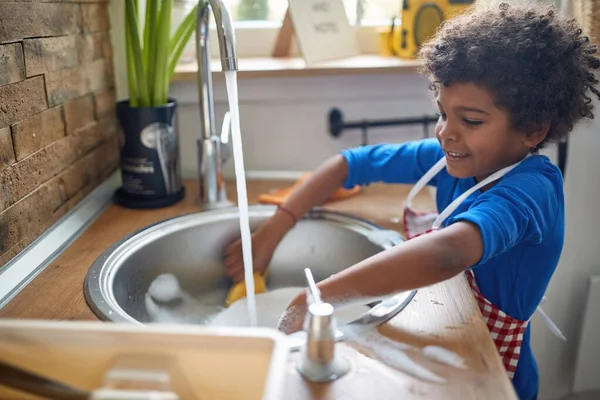 Young Adorable Boy Apron Standing Kitchen Sink Washing Dishes Plates — Stock Photo, Image