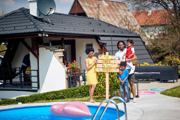 Afro American Family Standing Proudly Home Holding Sign Signifies Availability Stock Image