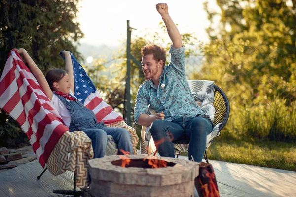Cheerful Little Girl Usa Flag Sitting Outdoors Fireplace Her Father Royalty Free Stock Images