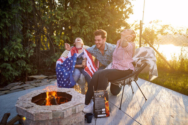 Joyful Man Woman Daughter Sitting Fireplace Outdoors Roasting Marshmallows Laughing Royalty Free Stock Images