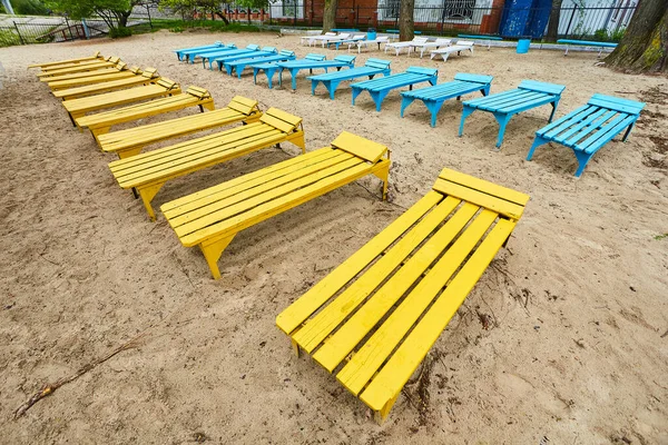 Old sun beds on an abandoned beach. People do not go to rest in nature