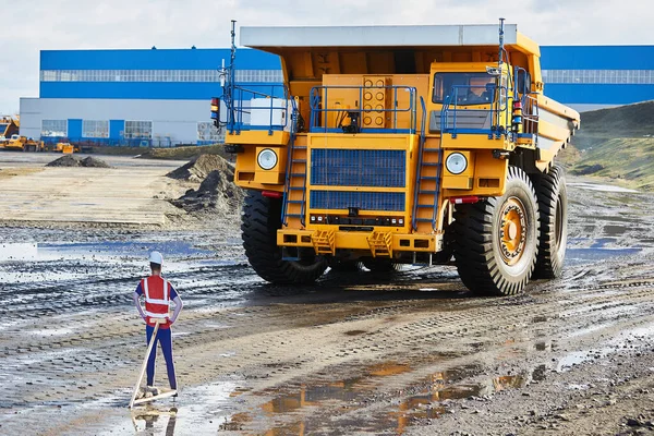 The dump truck, which is controlled remotely, works on the site and goes around the layout of a person