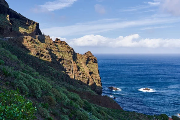 stock image Dangerous mountain road on the background of the ocean. Landscape in a mountainous area near the edge of the island