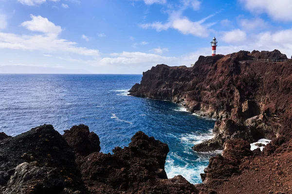 stock image Lighthouse on a high rock. Seascape with a view of the water and sky