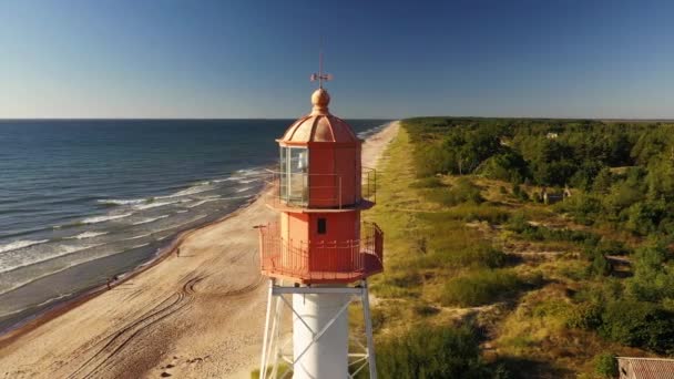 海岸上的风景 有美丽明亮的红色灯塔和汹涌的潮水 — 图库视频影像