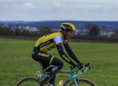 Vendome,France- March 7,2016:The Dutch cyclist Jos van Emden of Team LottoNL-Jumbo riding on a dirty road,Tertre de la Motte, in Vendome, during the first stage of Paris-Nice 2016. clipart