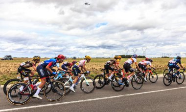 Rubelles, France - July 25th, 022: The peloton rides in the field during the second stage of Le Tour de France femmes 2022 clipart