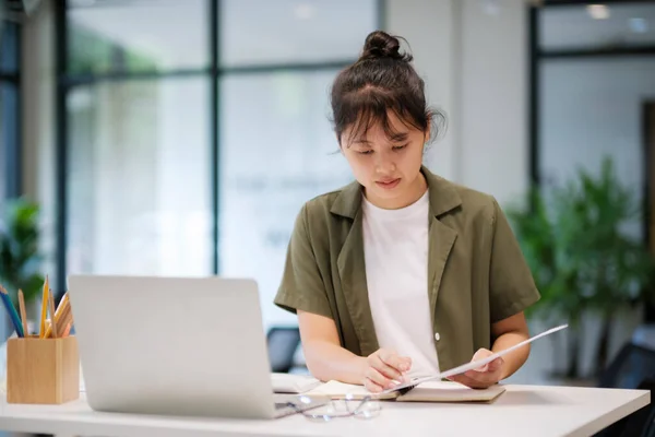 年轻的亚洲女商人在总部的笔记本电脑上工作 利用计算机在线学习 虚拟培训 在总部观看在线教育网络研讨会的亚洲女学生或远程教师 — 图库照片