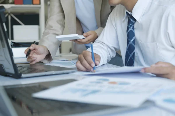 stock image Businesspeople or office workers are working together on investment project. They are discussing, sharing the ideas, planning, and analyzing the business strategy. And set up the budget for financial plan by using laptop and calculator.