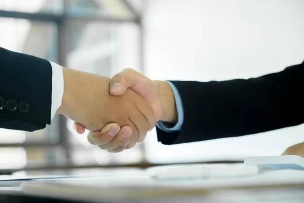 The businessman and his partnership are agree with their concept. The image of two businessman are shaking hands together. The successful persons are shaking hands after have a good deal with their