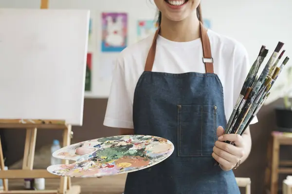 Close Artist Hands Wearing Apron Smeared Paint Clutching Many Brushes — Stock Photo, Image