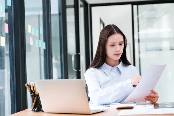 Focused Female Professional Intently Reviewing Document Her Office Desk Laptop Stock Photo